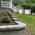 retaining wall, stone steps, garden wall, backyard landscaping, hardscape design, outdoor stairs, slope stabilization, landscape architecture, curved retaining wall, interlocking blocks, elevated garden, front yard landscaping, tiered wall, hillside design