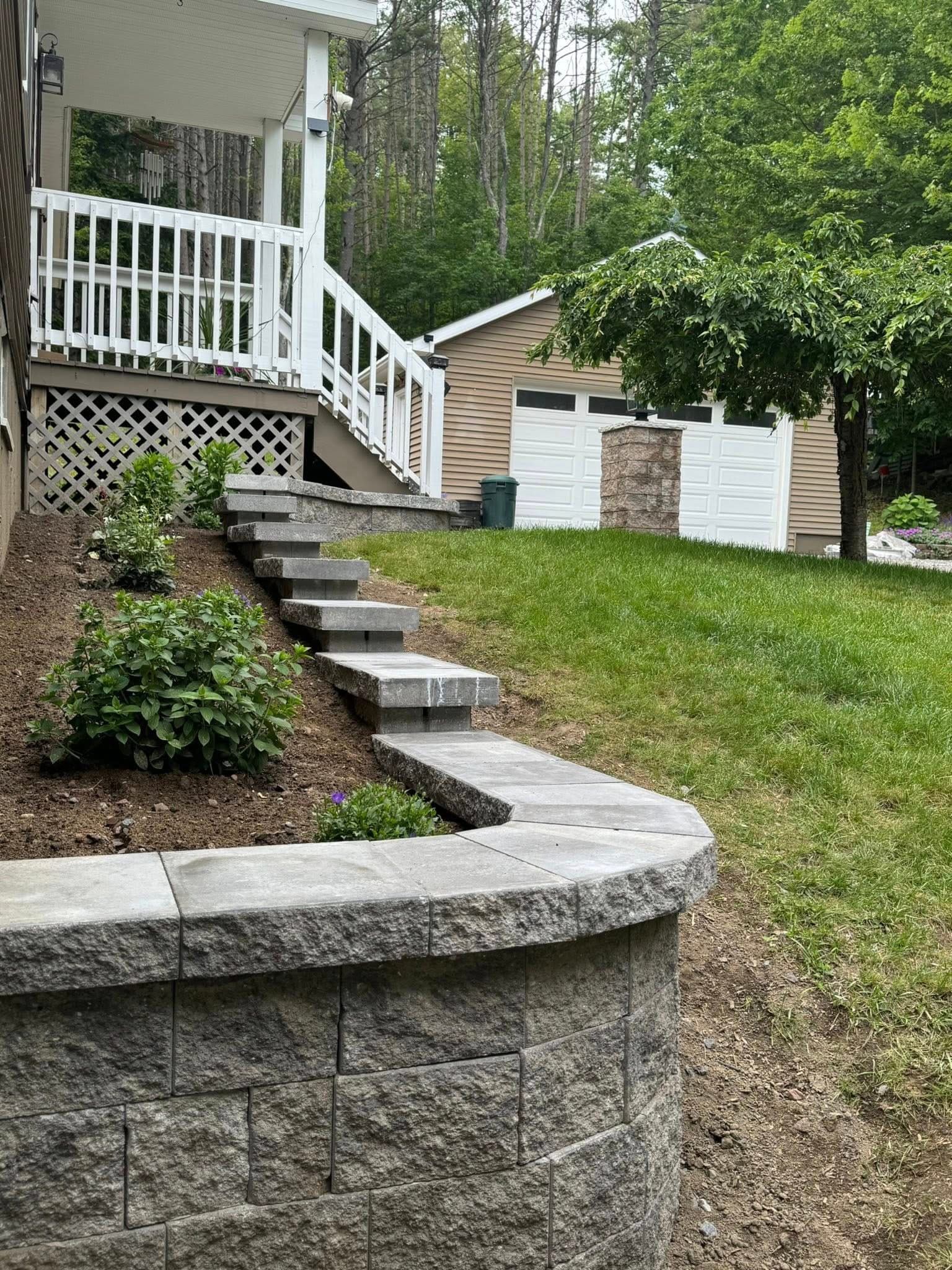 Past Projects 1 retaining wall, stone steps, garden wall, backyard landscaping, hardscape design, outdoor stairs, slope stabilization, landscape architecture, curved retaining wall, interlocking blocks, elevated garden, front yard landscaping, tiered wall, hillside design
