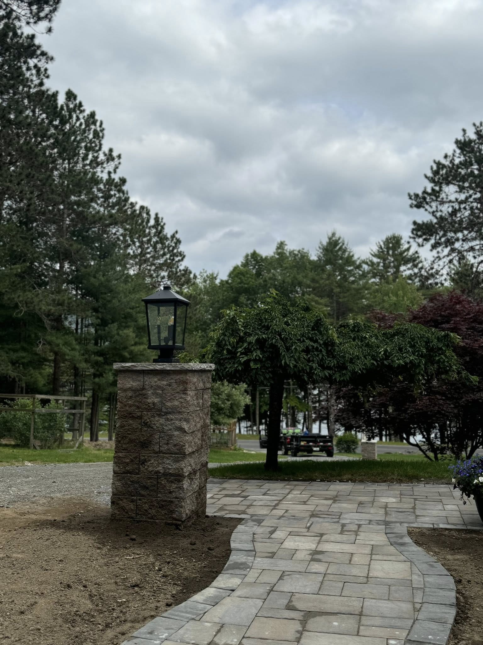 paver walkway, stone pillar, outdoor lighting, garden path, patio walkway, hardscape design, backyard landscaping, landscape lighting, walkway ideas, brick pavers, outdoor design, curb appeal, front yard path