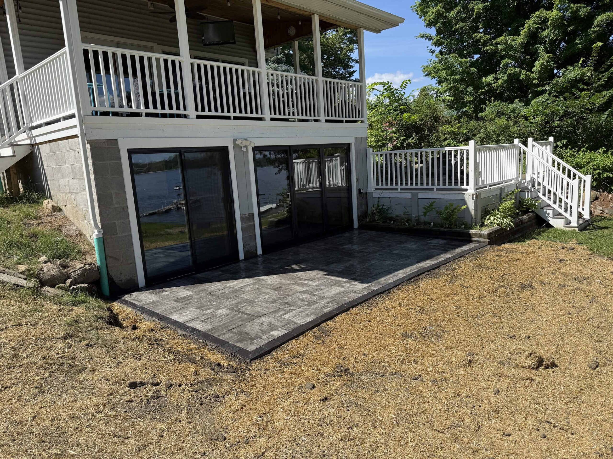 Home 14 Cambridge paver patio installed beneath an elevated deck in a residential backyard