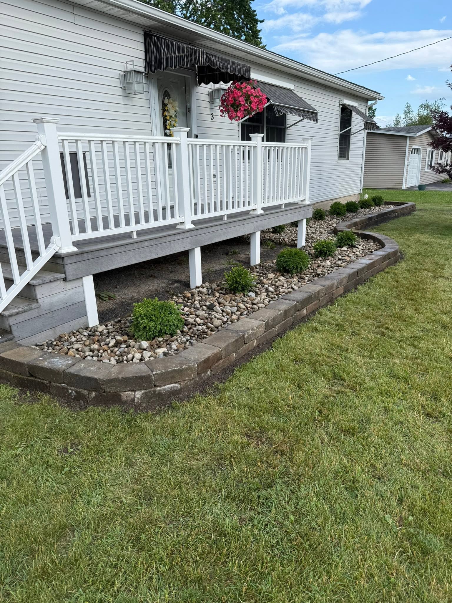Home 15 Small Cambridge retaining wall with landscaped garden bed and decorative shrubs along front porch
