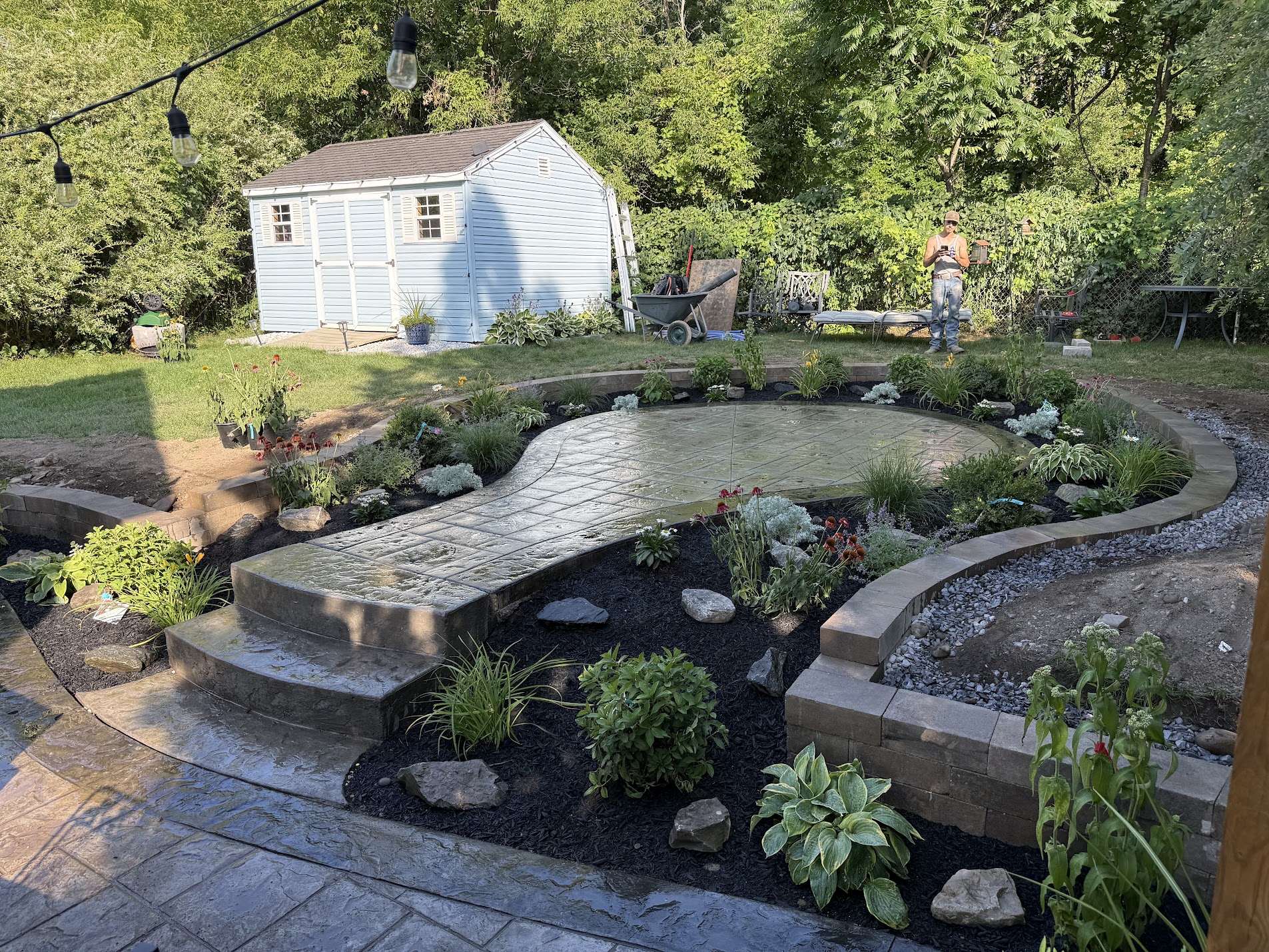 Home 9 Custom Cambridge sunken paver patio with retaining walls, natural stone steps, and landscaped garden beds